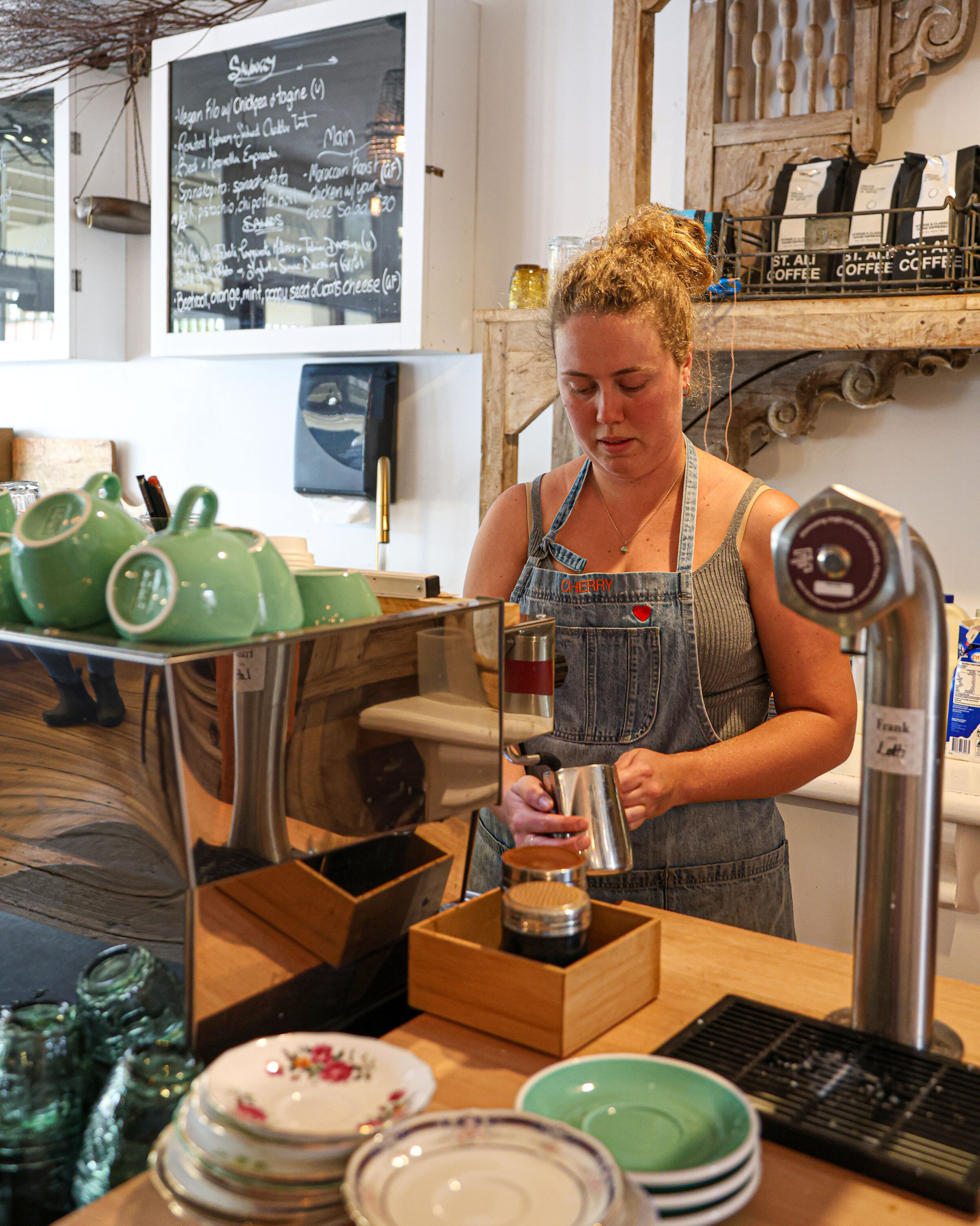 Barista pouring milk in a specialty café